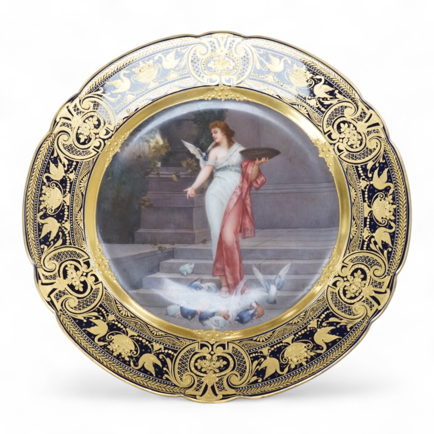 A Vienna-style cabinet plate, painted with a Vestal Virgin, after P. Wagner, depicting a lady feeding pigeons, signed Goget?, 24cm in diameter